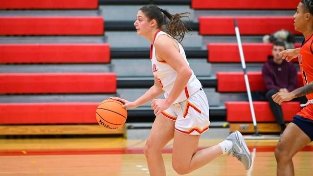 Mia Kalich dribbles the basketball.