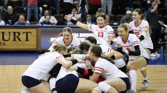 MSU Denver forms a dogpile at center court after advancing to the finals of the DII women's volleyball championship. 